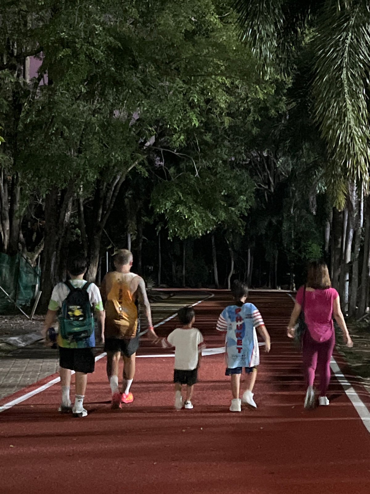Daily life captured across Phuket: running, tourism signs, evening gatherings