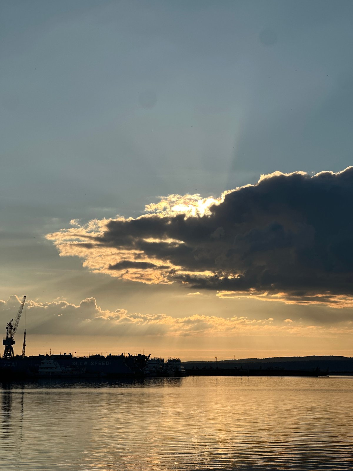 Golden hour at an industrial waterfront, sunset views all around