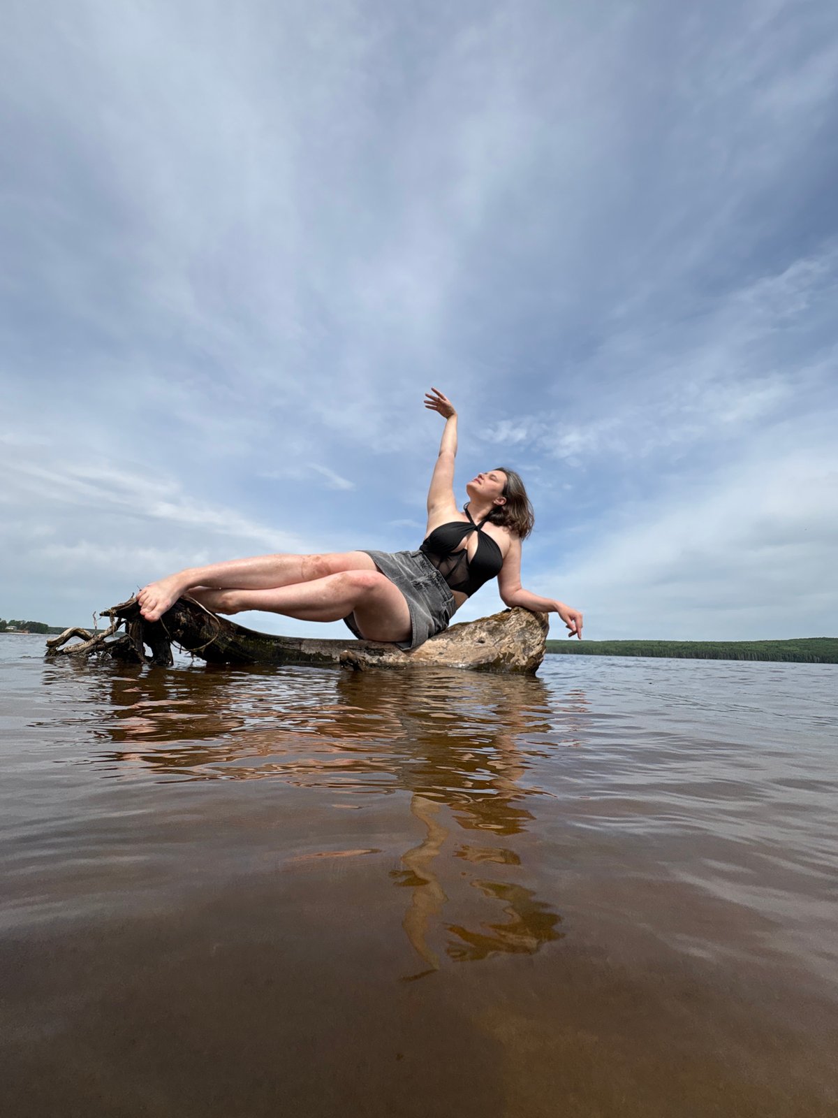 Woman poses for photos along Chaikovsky waterfront during morning