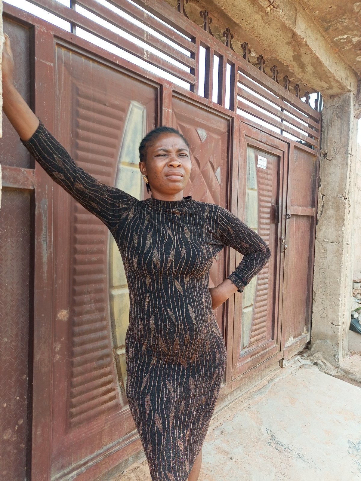 Casual portraits near a gate and wall in Tempure, Nigeria