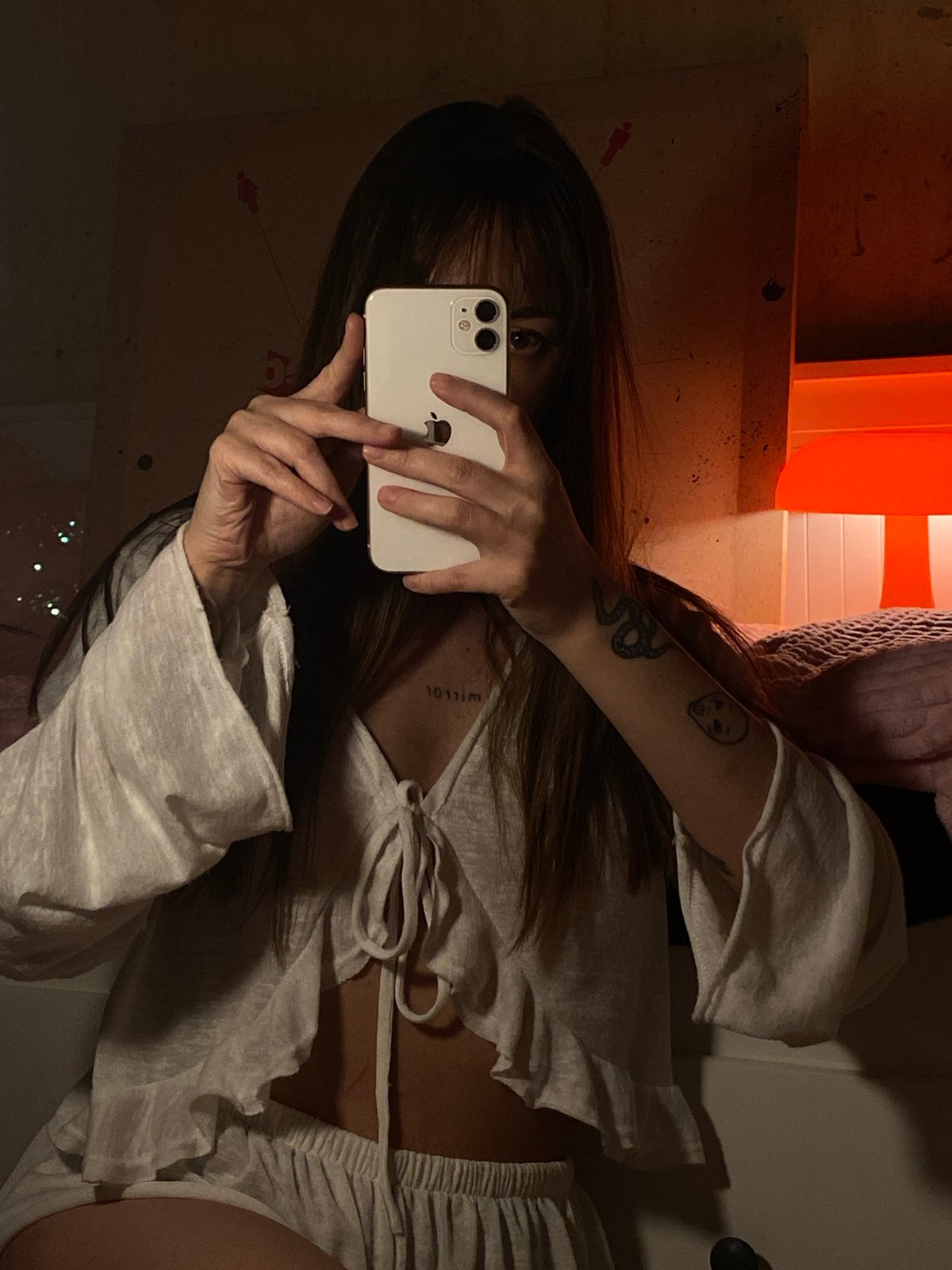 Person takes mirror selfie in cluttered room, Votkinsk