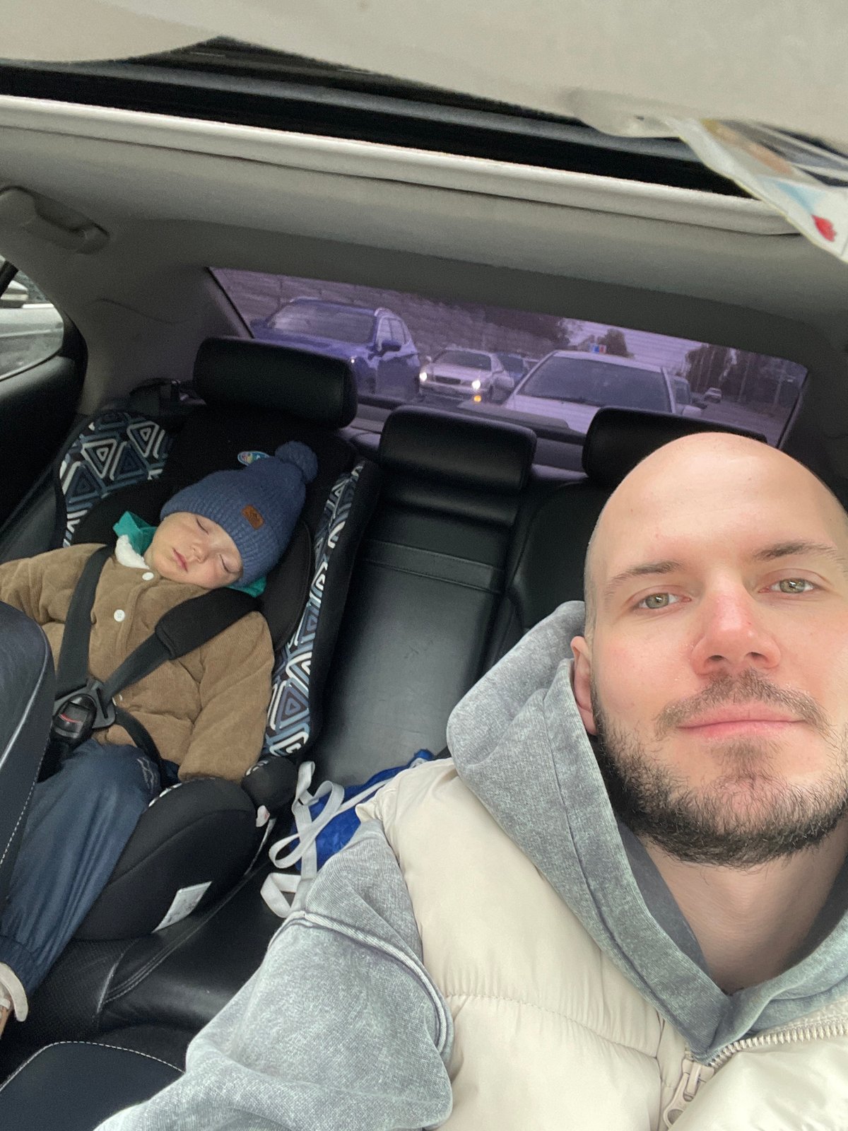 Father and child take selfie in car in Krasnoyarsk