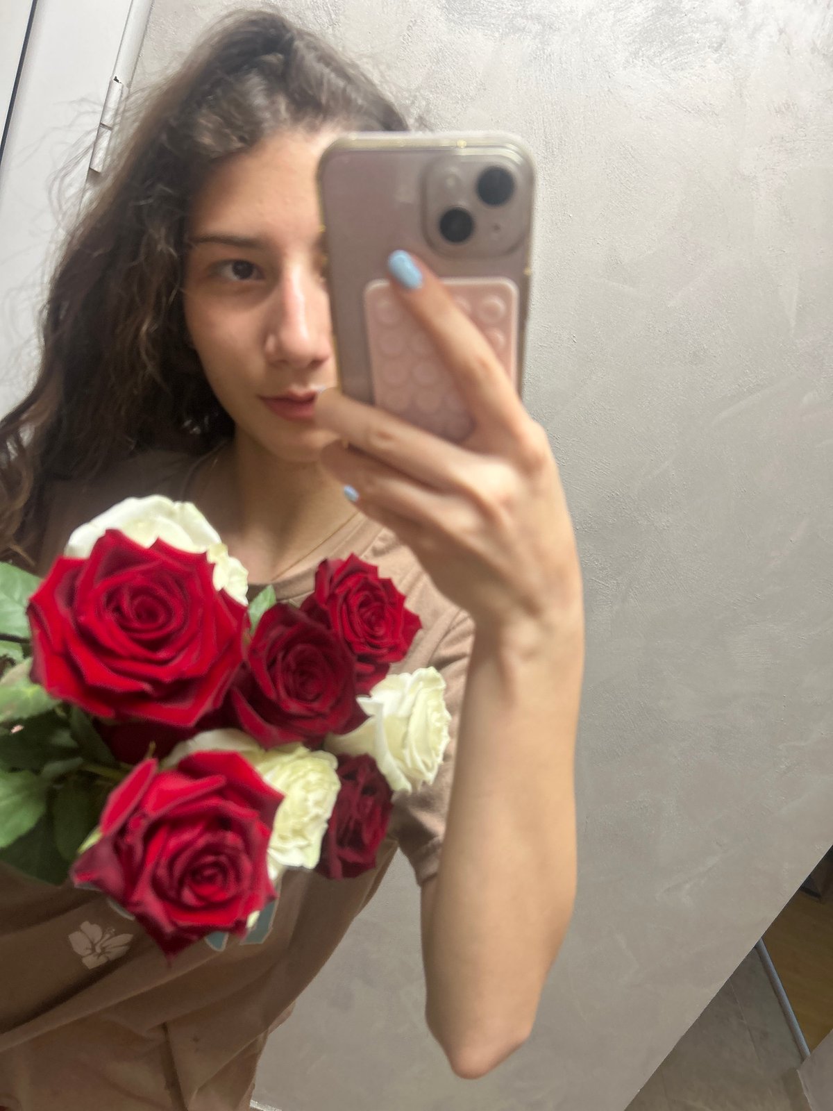 Woman photographs herself with roses, cat photobombs session