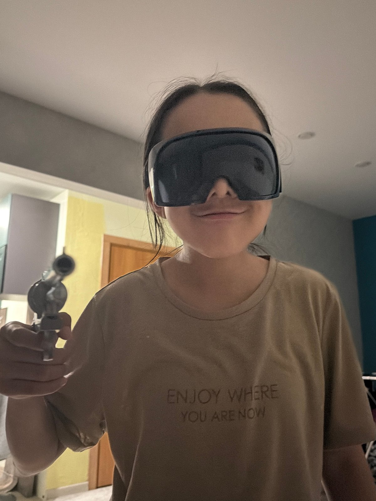 Person in sunglasses with glass pipe observed resting indoors