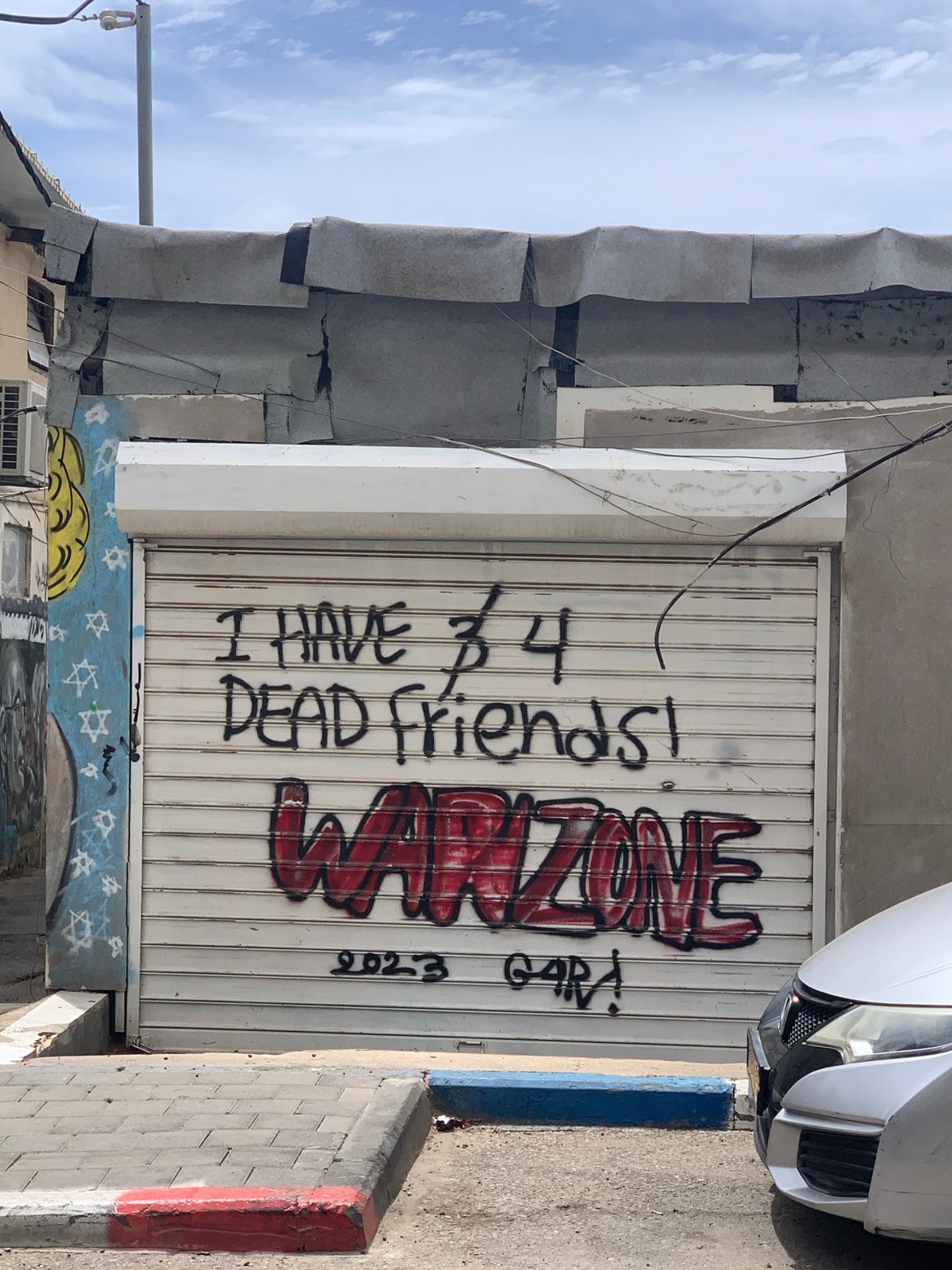 Graffiti about dead friends spotted on Tel Aviv security gate