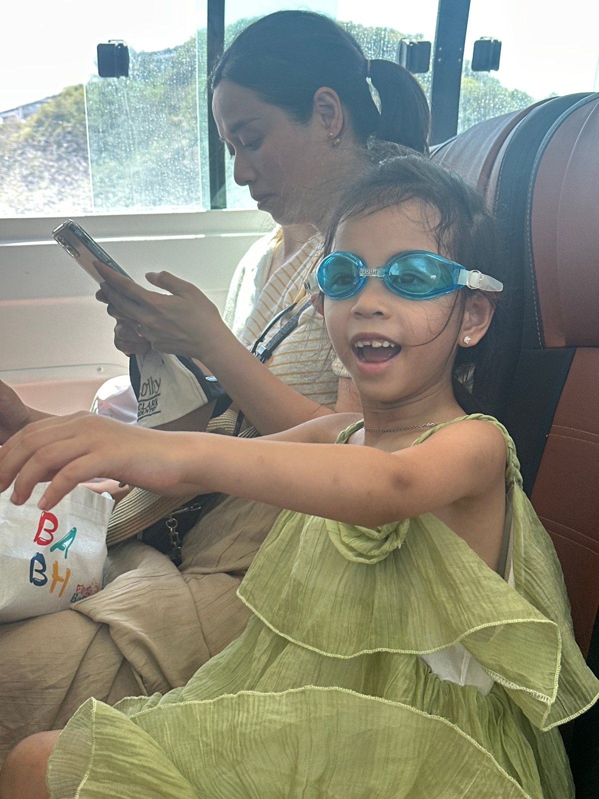 Bus passengers use smartphones during daytime transit in Vietnam