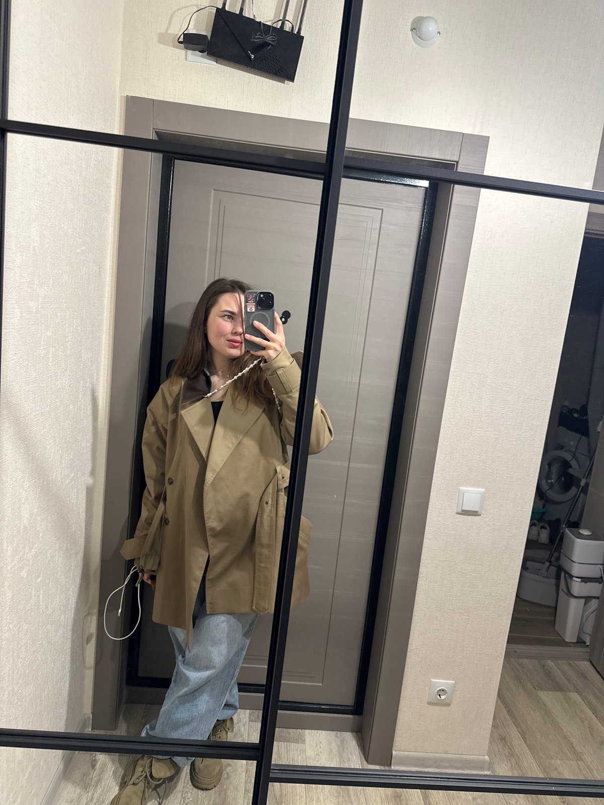 Woman takes mirror selfie in Perm hallway