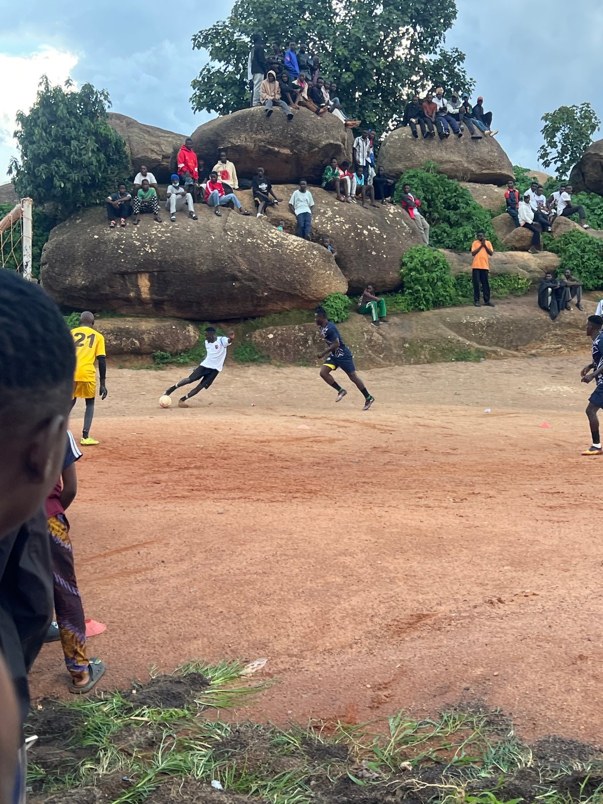 Pickup football on a dusty field in Jos, Nigeria