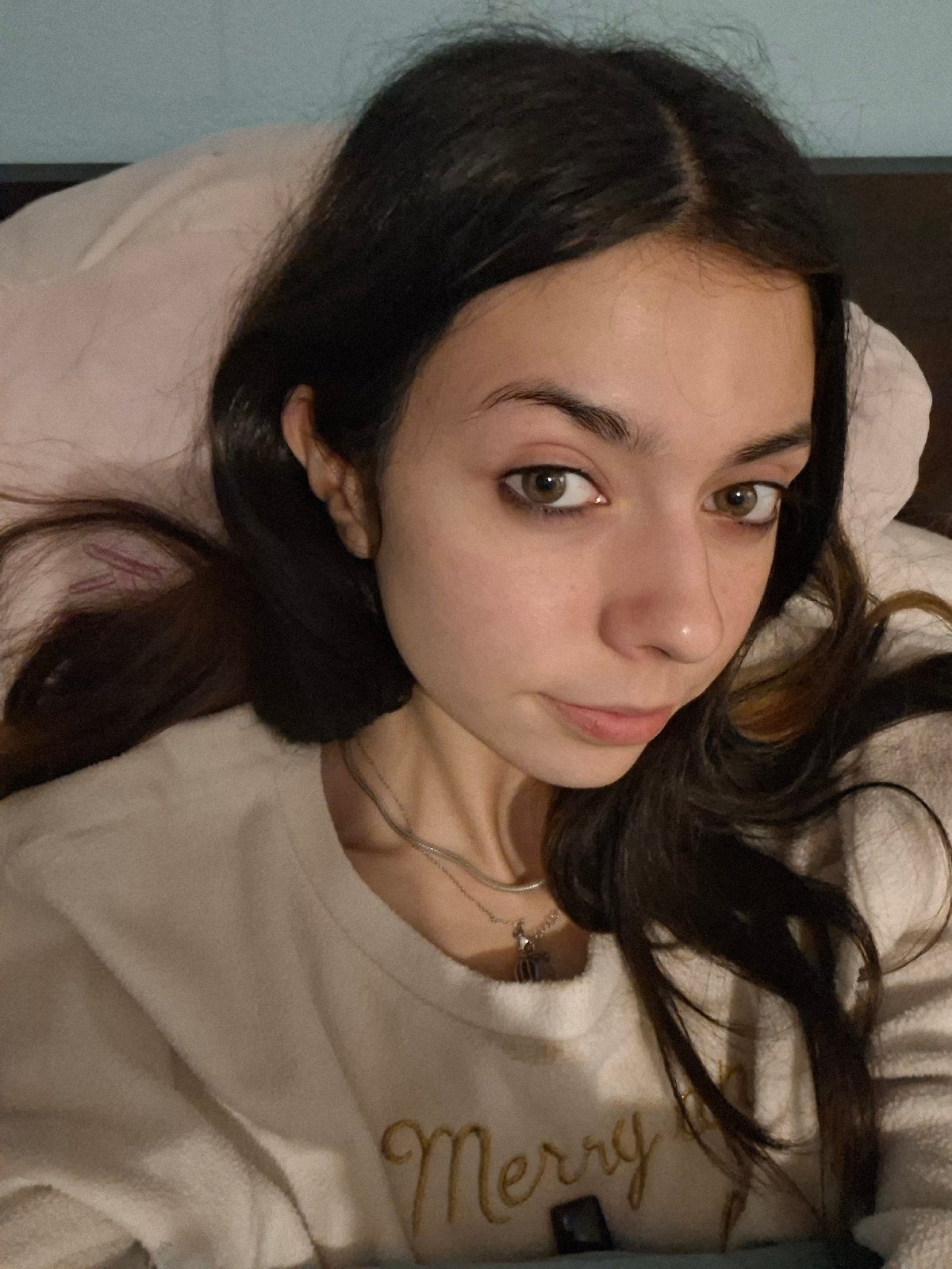 Woman rests on bed in Sofia room