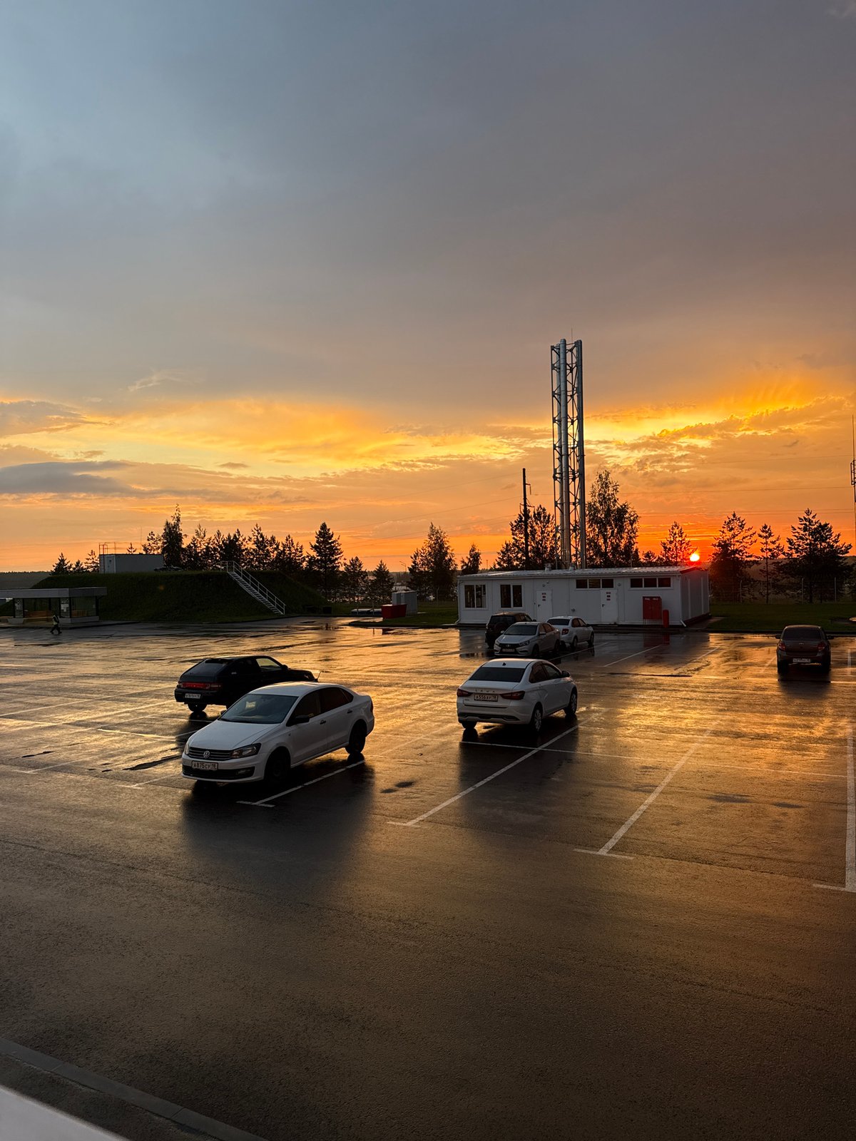 Vivid post-rain sunset over a Sarapul parking area