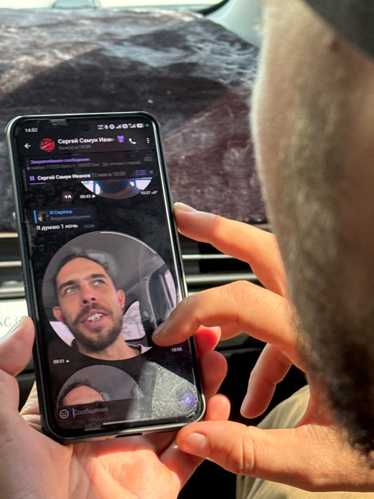 Person uses smartphone for calls, messaging in Hanoi vehicle