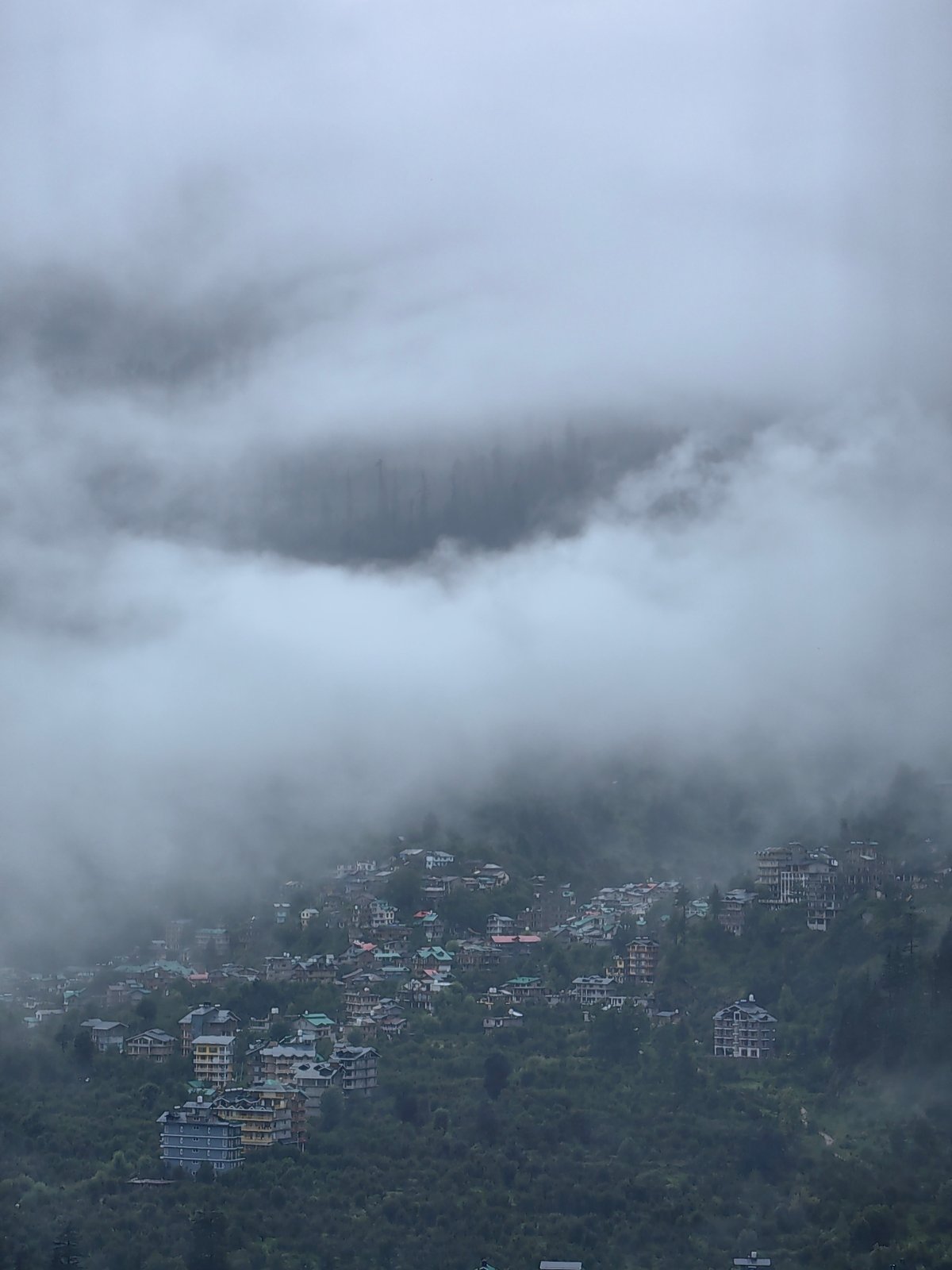 Foggy morning in Vashisht, quiet scenes from a misty hillside town