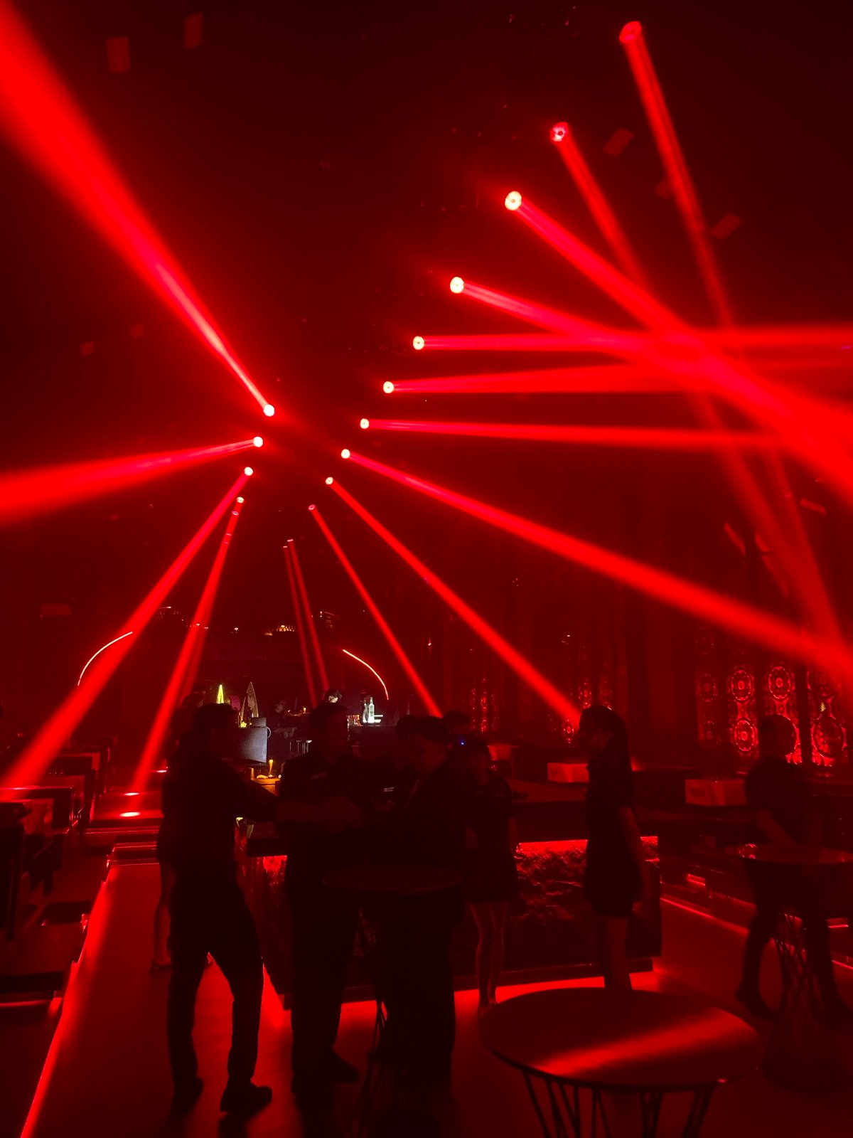 A night at a Bali club venue — DJ, dancers, and neon-lit bars