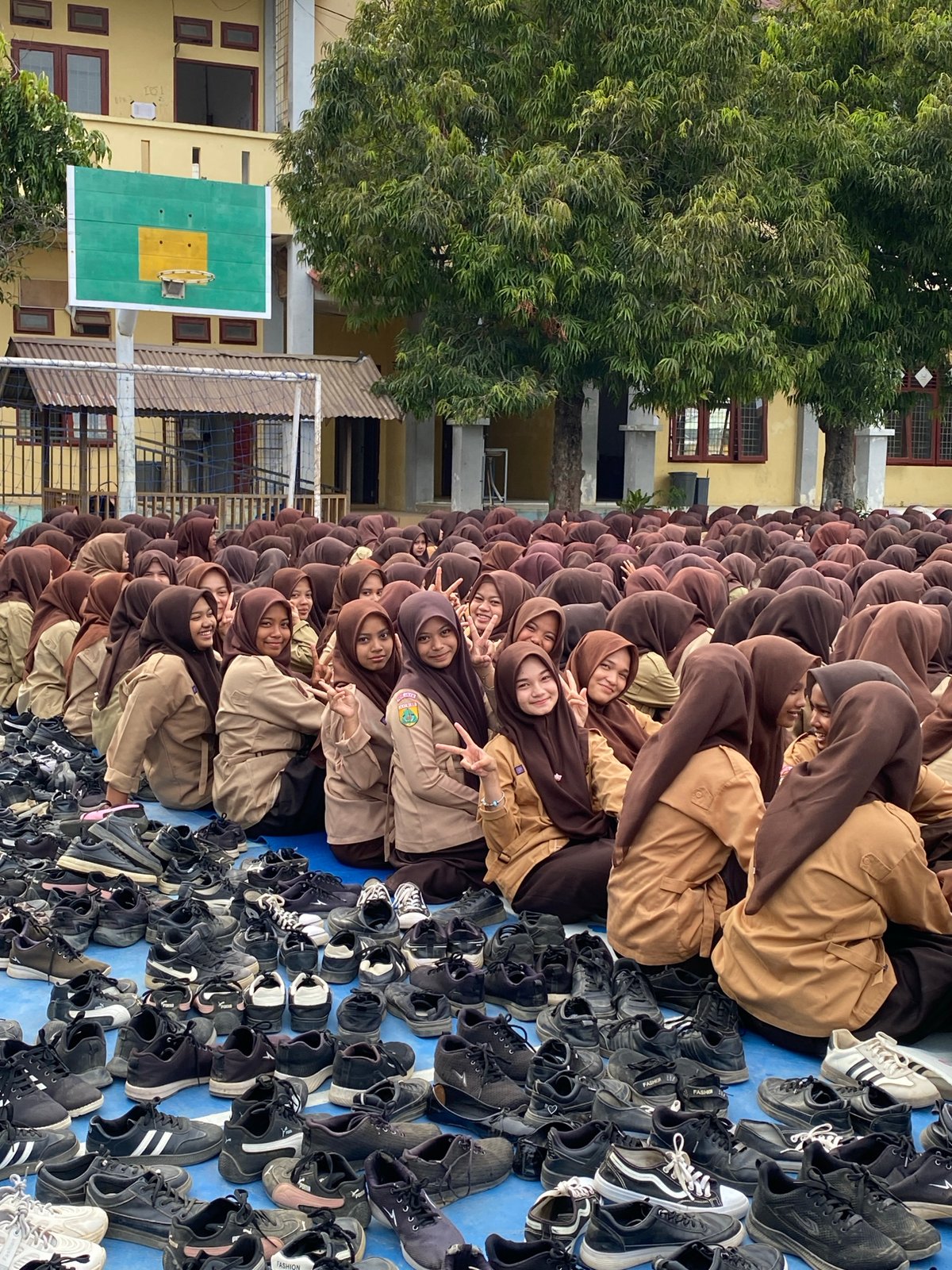 School assembly on a blue court, students in uniform