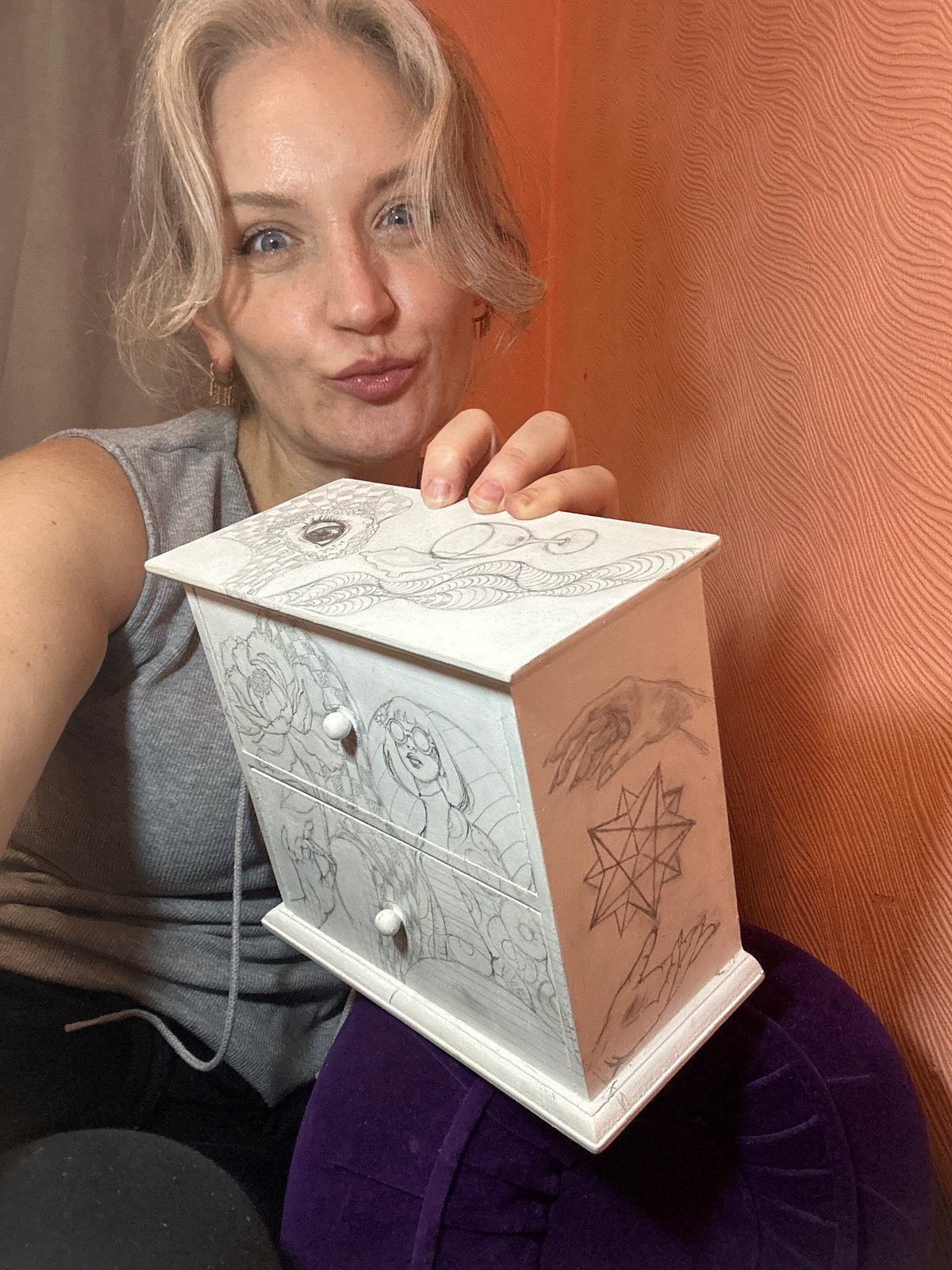 Hand-drawn pencil art decorates a wooden jewelry box in Kyiv