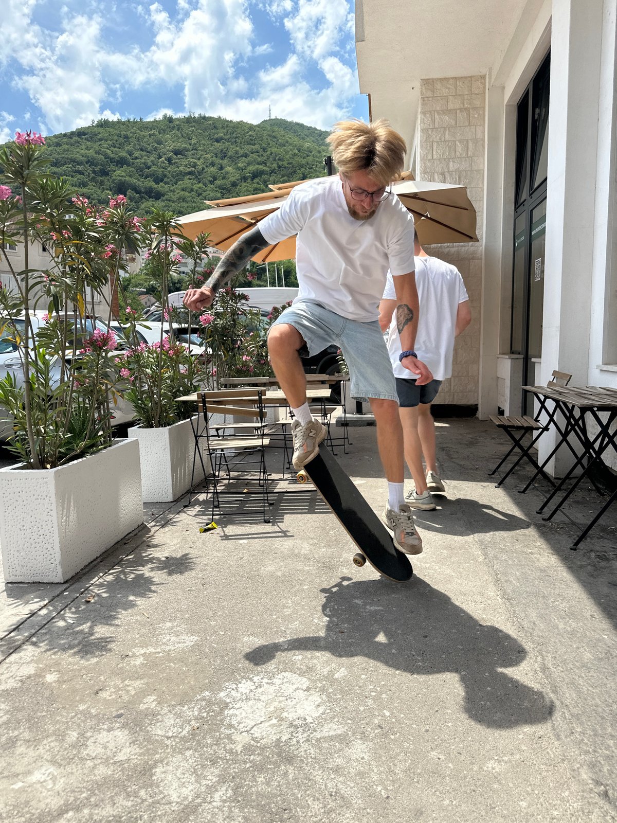 Skateboarding and dog watching city life captured in Budva