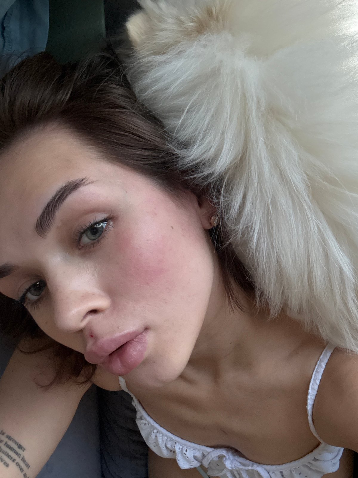 Woman with white dog photographed indoors in Лобаново, Russia