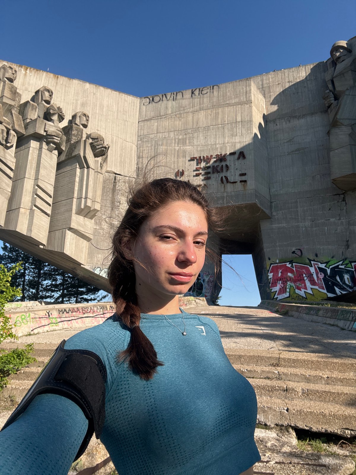 Tourists take playful photos at Buzludzha Monument in Varna
