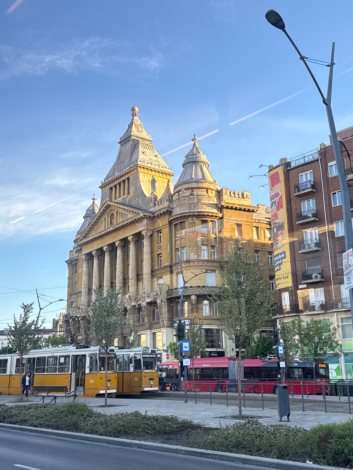 Historic yellow tram operates alongside traffic in Budapest streets