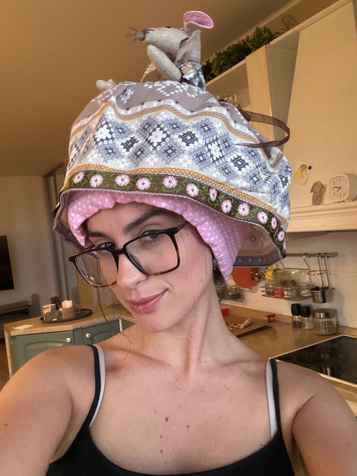 Woman and cloth mouse doll spotted in kitchen setting