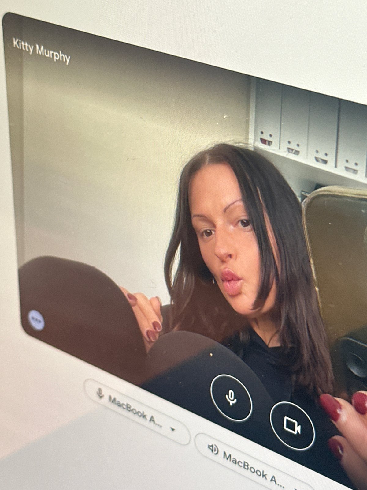 Video call participant captured on laptop screen in Kent