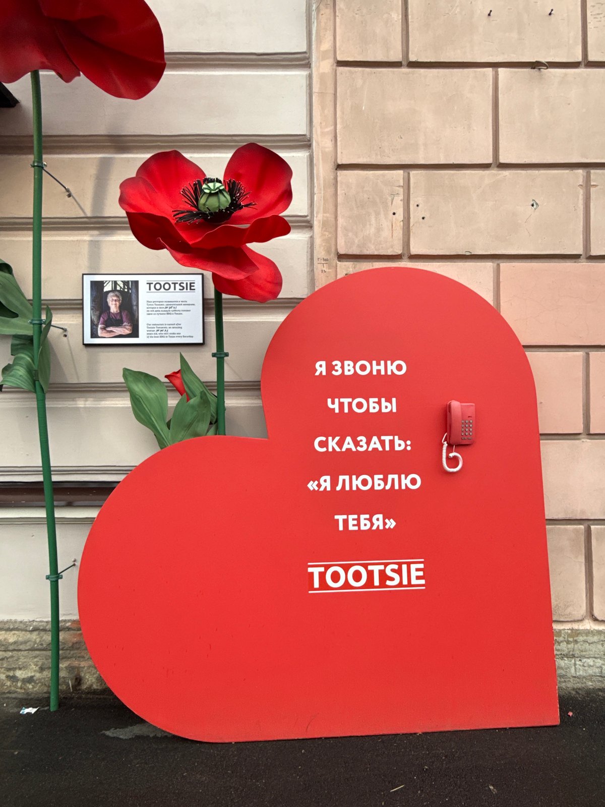 Woman uses decorative love-themed public phone in Saint Petersburg