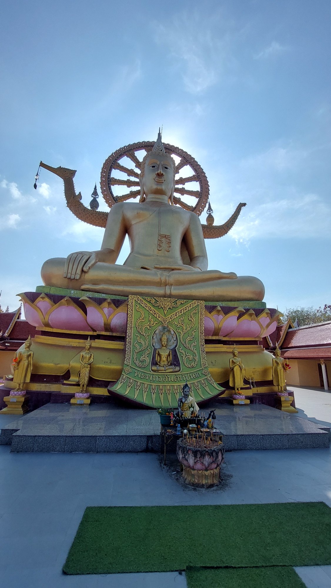 Temple visitor documents Buddhist statues at Baan Plai Laem