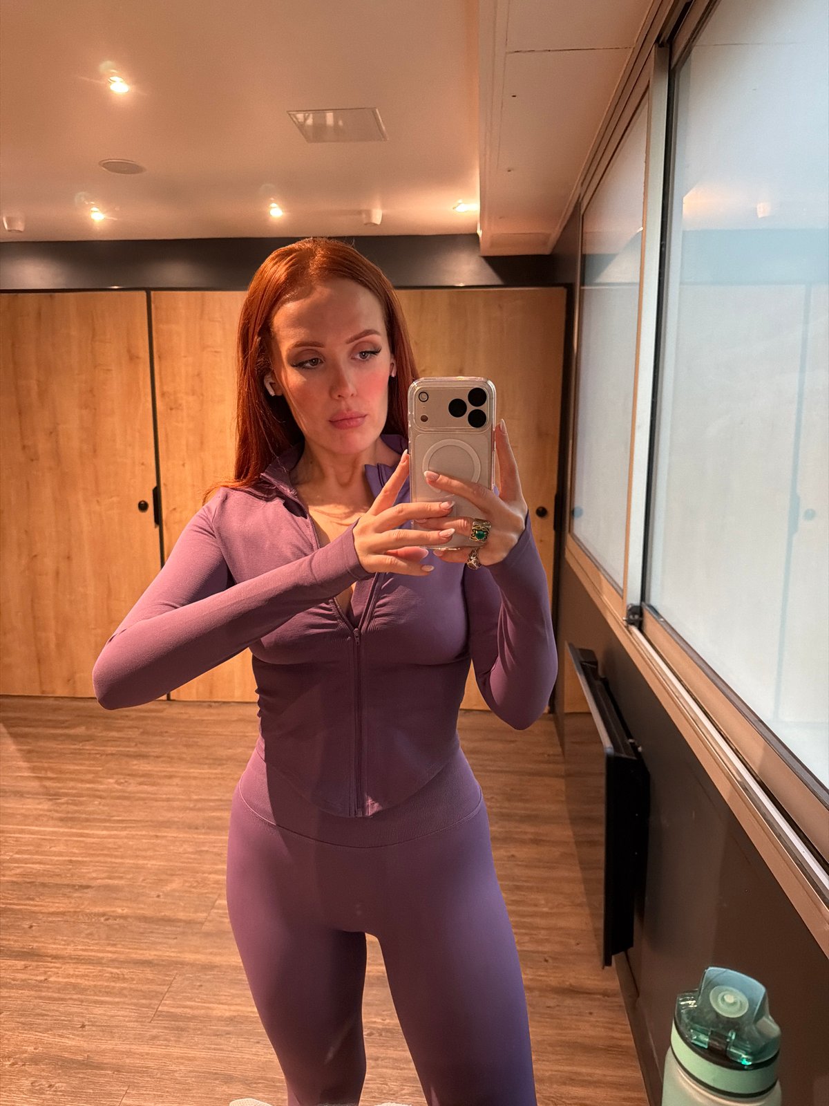 Woman takes gym selfie in purple tracksuit, Paris
