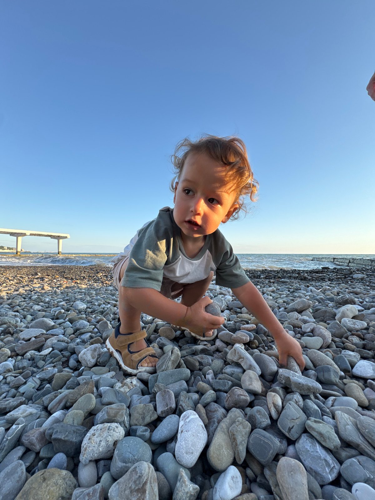 Golden hour on a Sochi pebble beach, summer evening