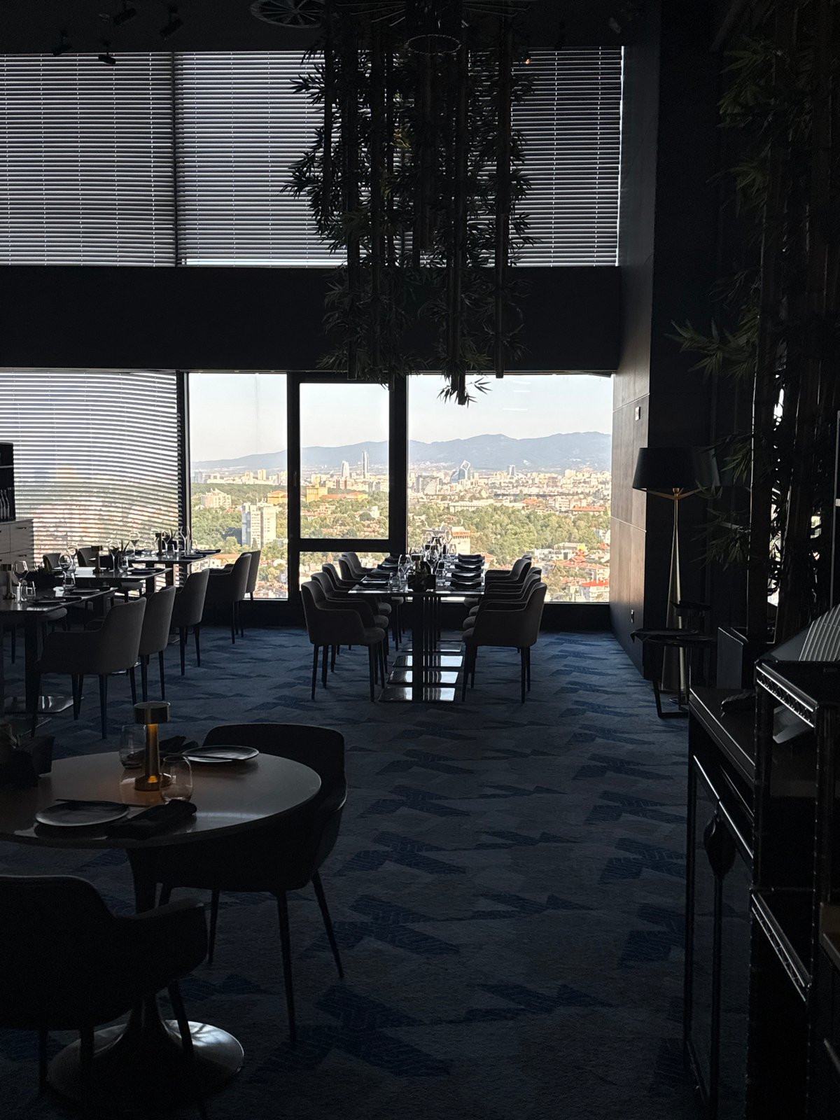 Upscale restaurant prepped for service, silverware cart mid-floor