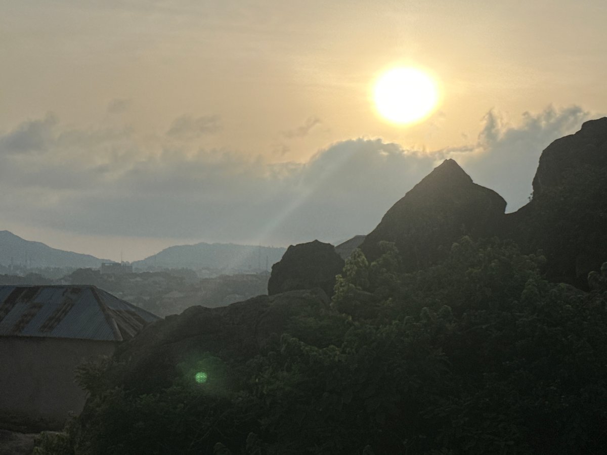 Morning scenes from Jos Nigeria show rocky settlements and cats
