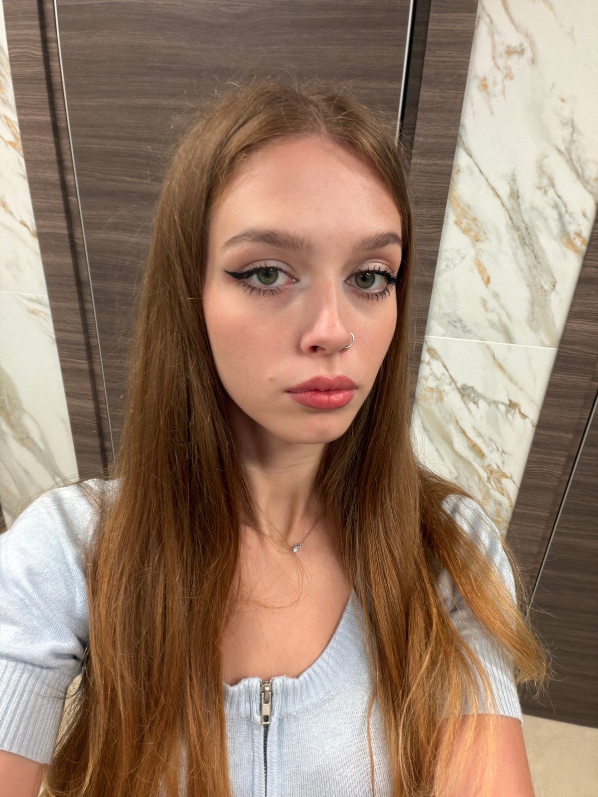 Quick selfie session in a light blue outfit, indoors