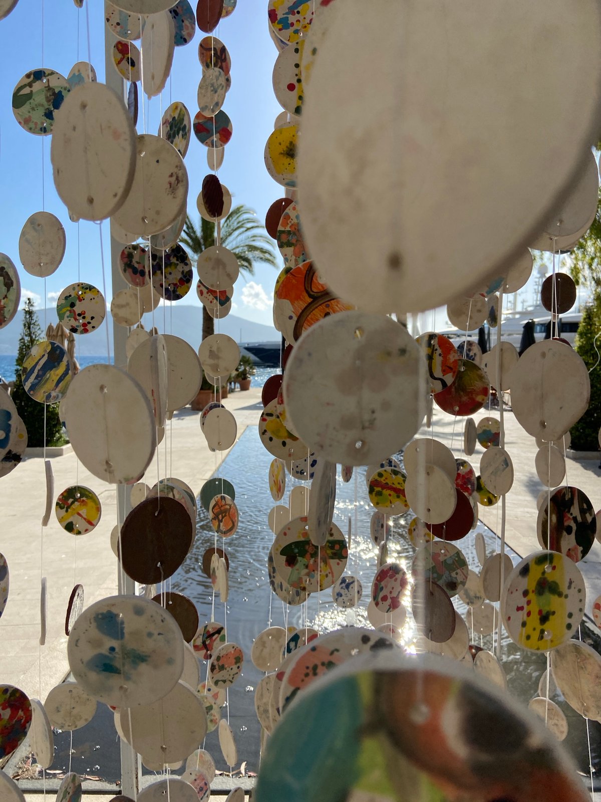 Tourist documents public art and street scenes in Tivat