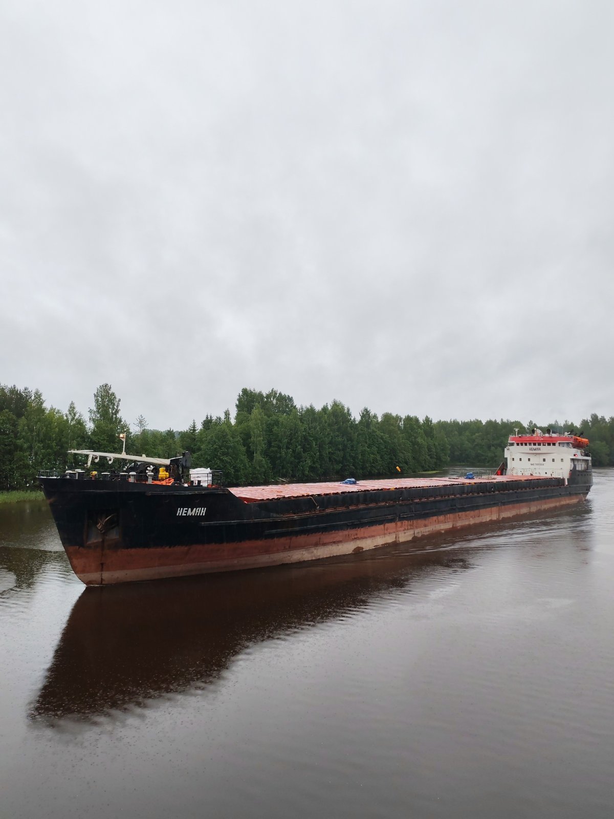 Cargo barge NEMAN transiting a calm Russian river