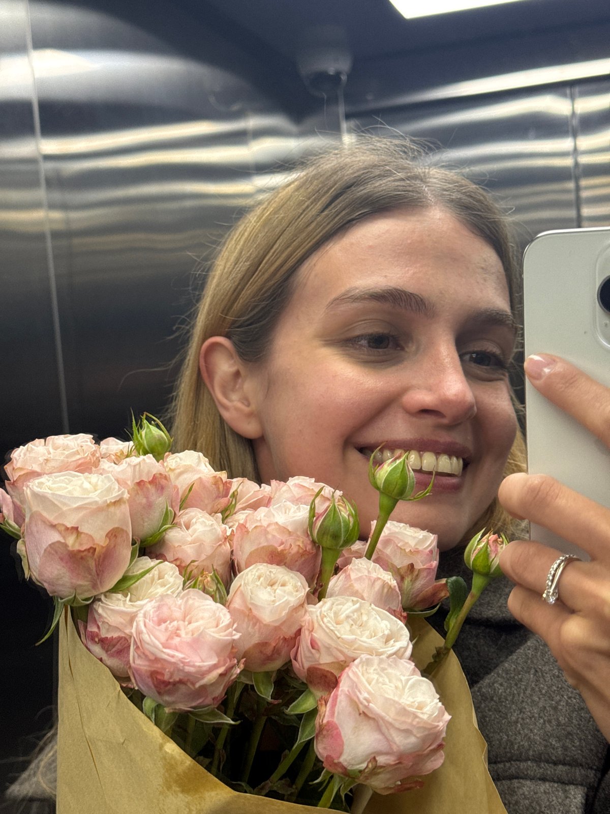 Woman Takes Elevator Selfies With Rose Bouquet