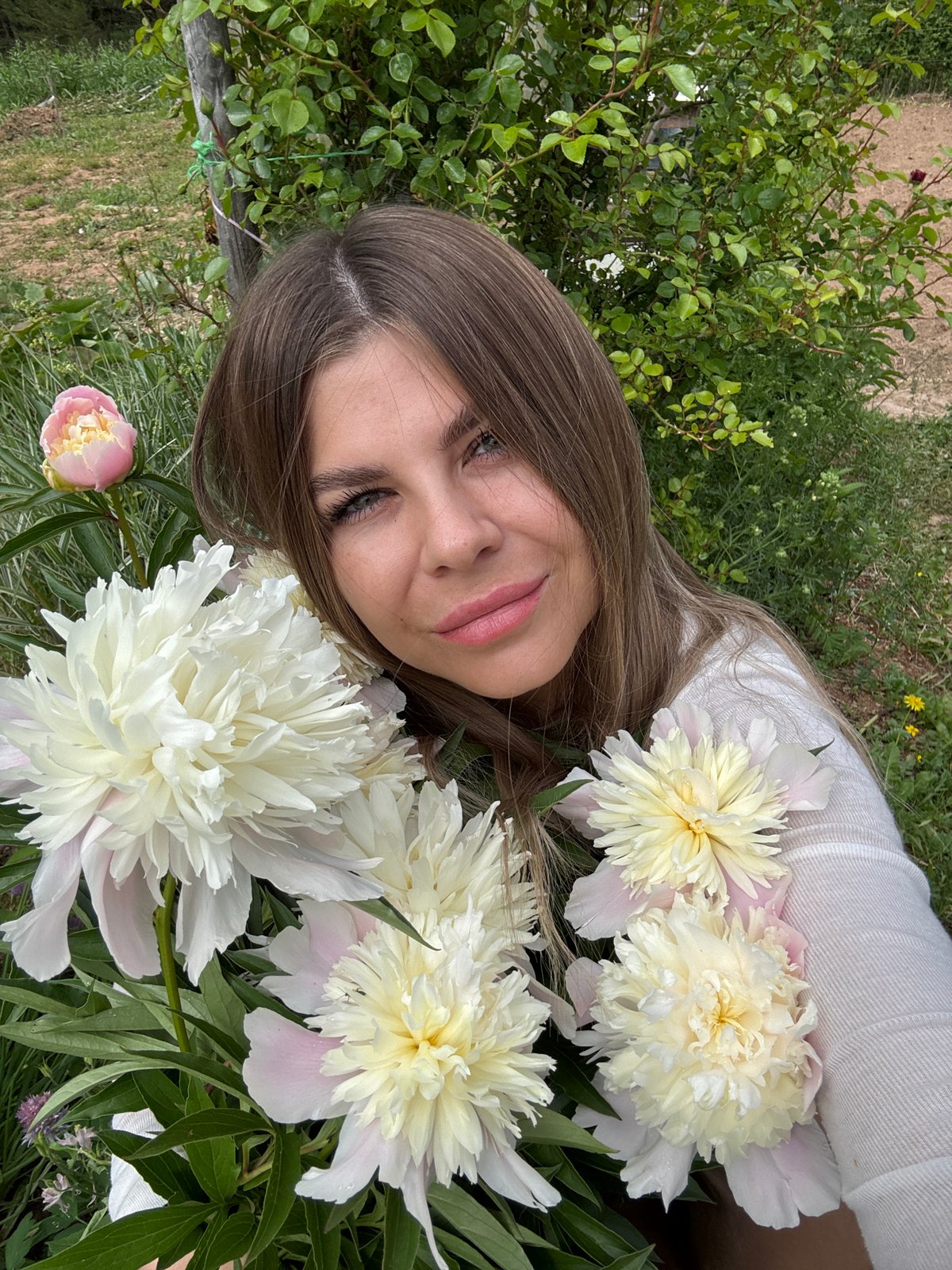 Woman photographs peonies, cat catches mouse in Фоки, Russia