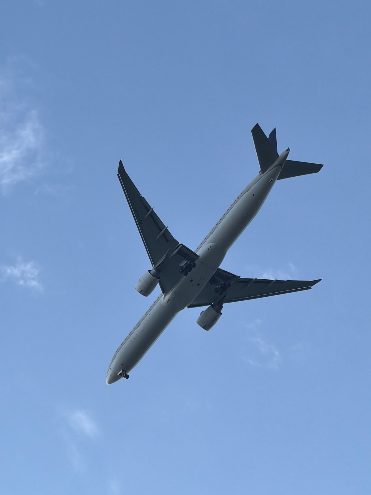 Planes overhead and Qutub Minar below on a cloudy Delhi afternoon