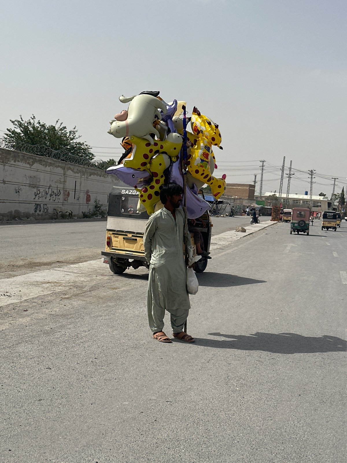 Balloon vendor pushes cart through Quetta streets