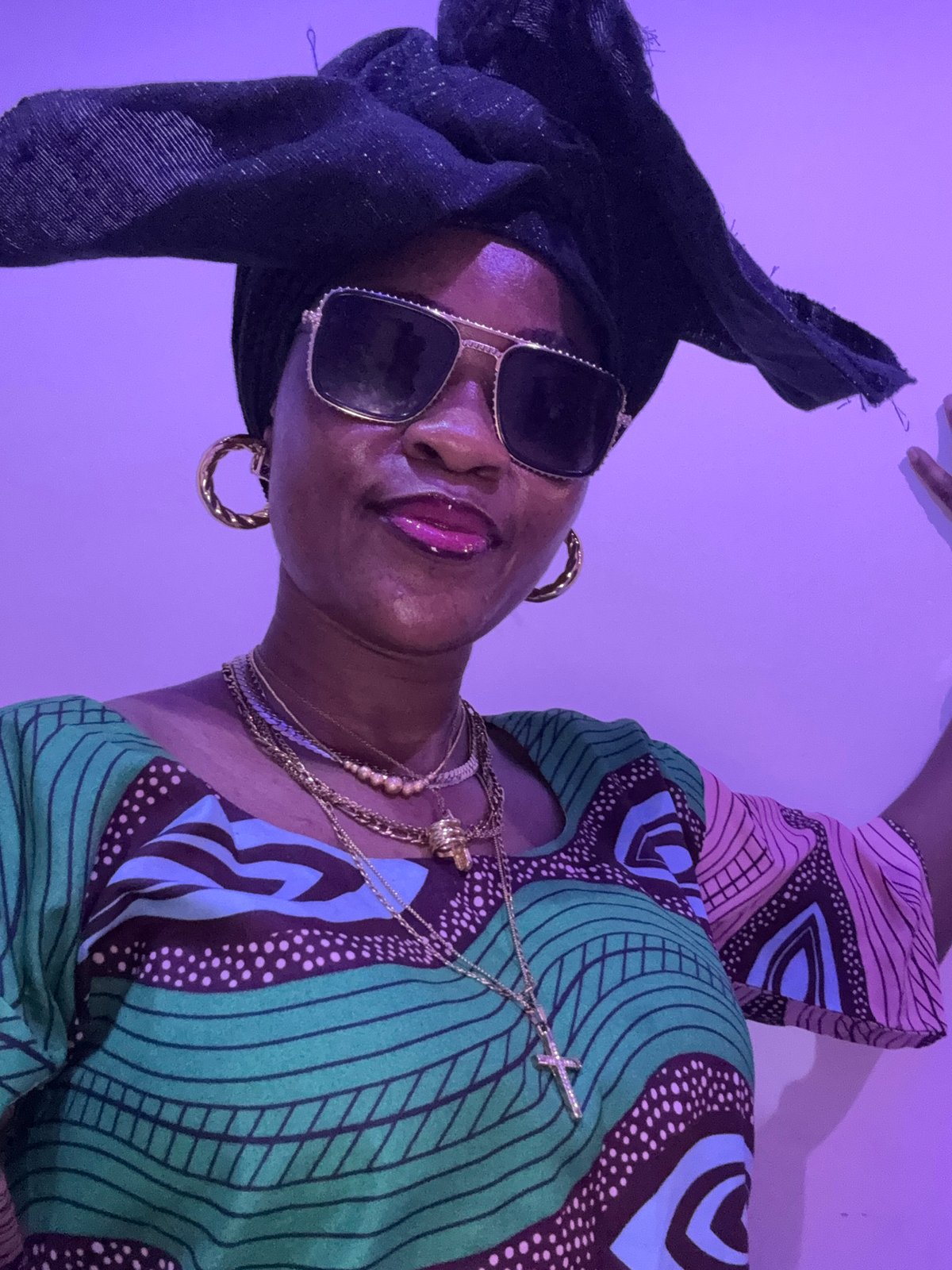Bold jewelry and patterned style in Ajara, Nigeria