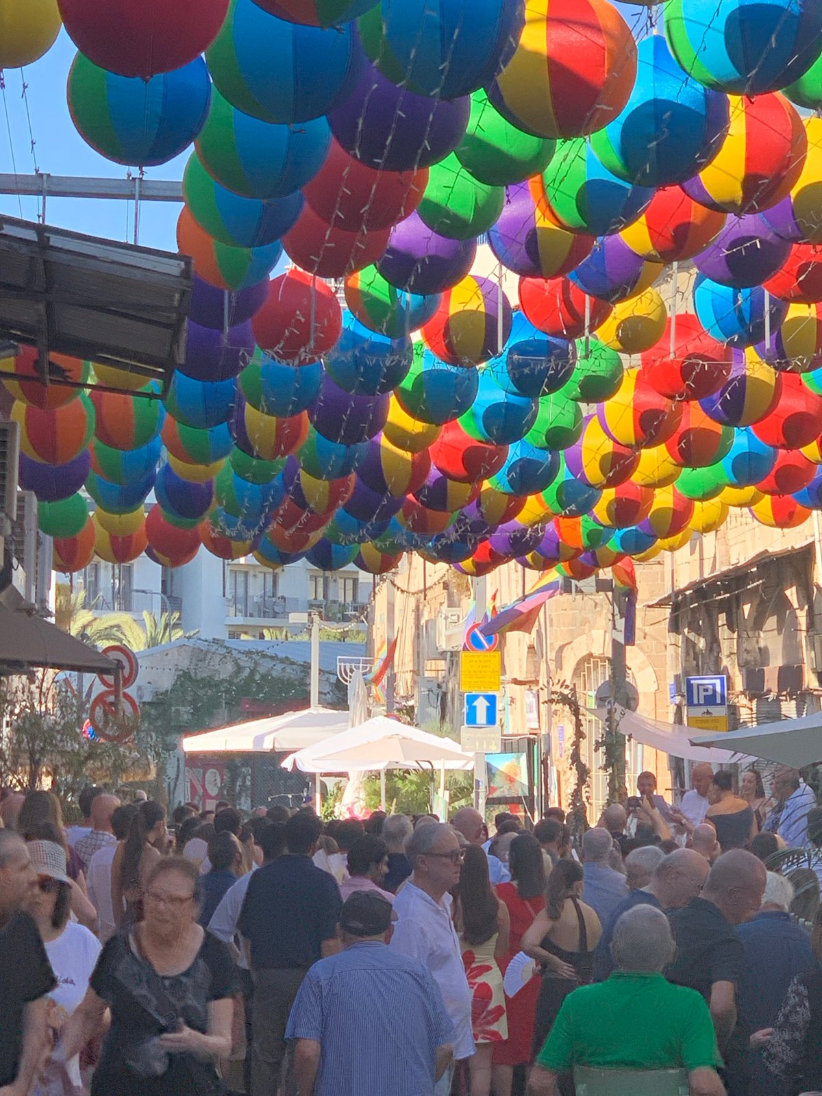 Canopy of colorful balloons lines a Tel Aviv street