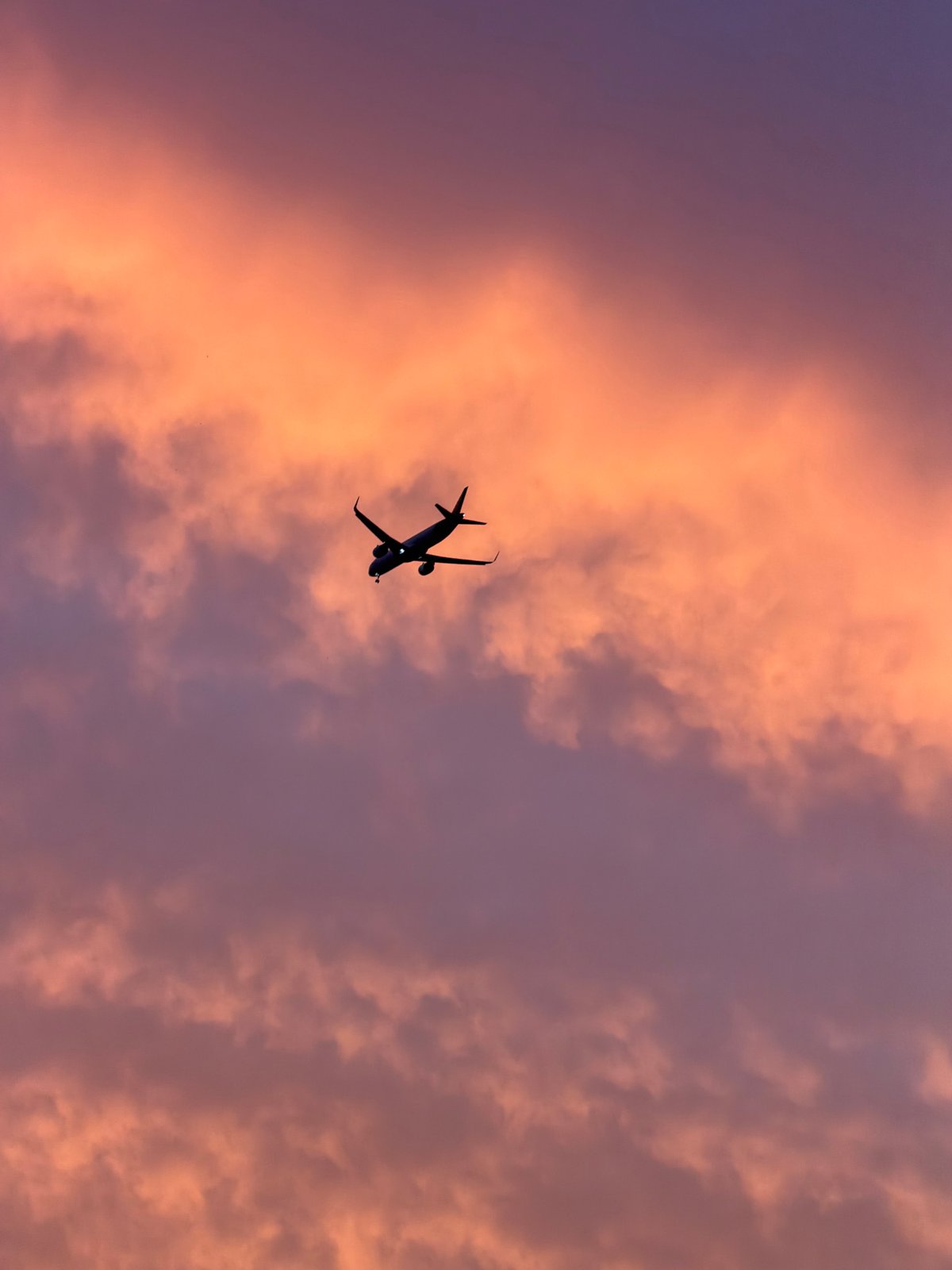 Aircraft spotted over Delhi rooftops during sunset near airport