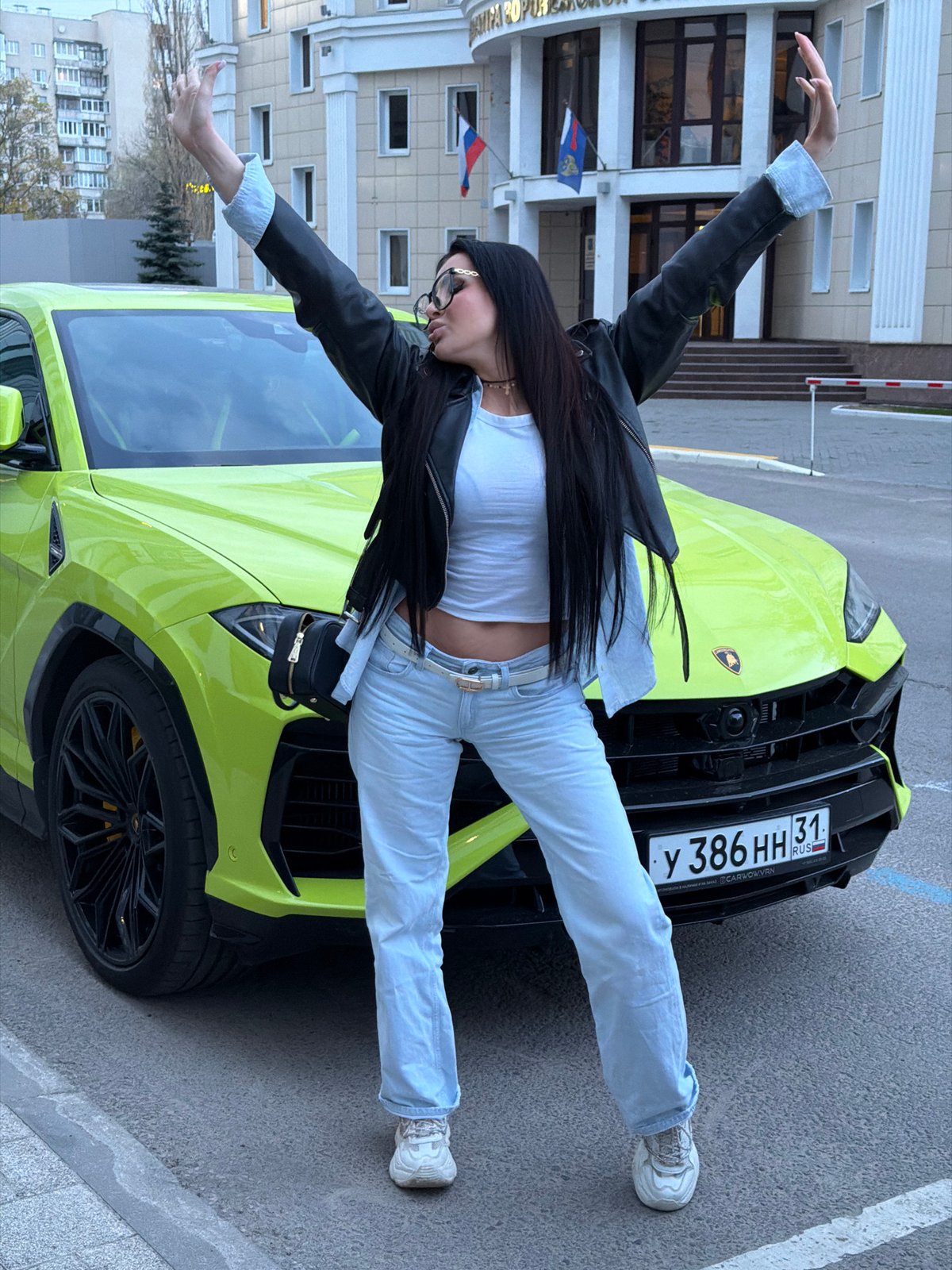 Woman poses on lime green Lamborghini in Voronezh