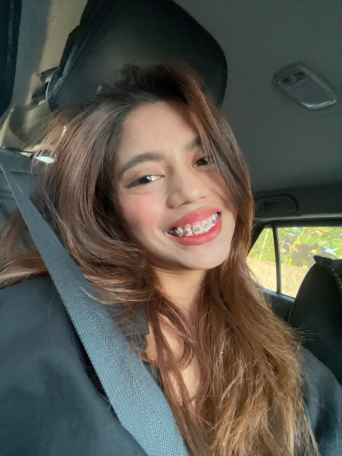 Woman takes selfies in vehicle passenger seat, Davao City