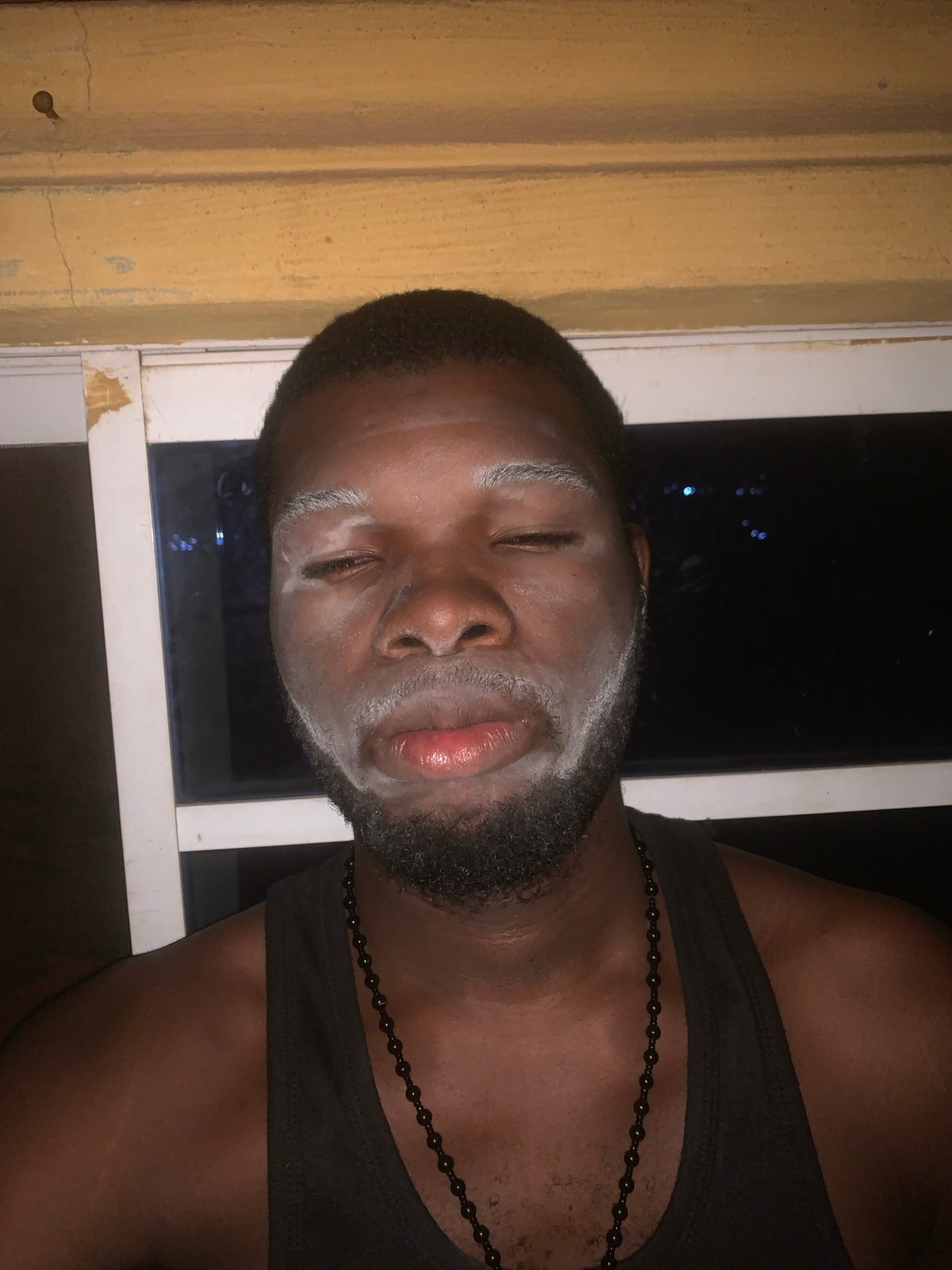 Nigerian resident documents evening skincare routine with white face mask