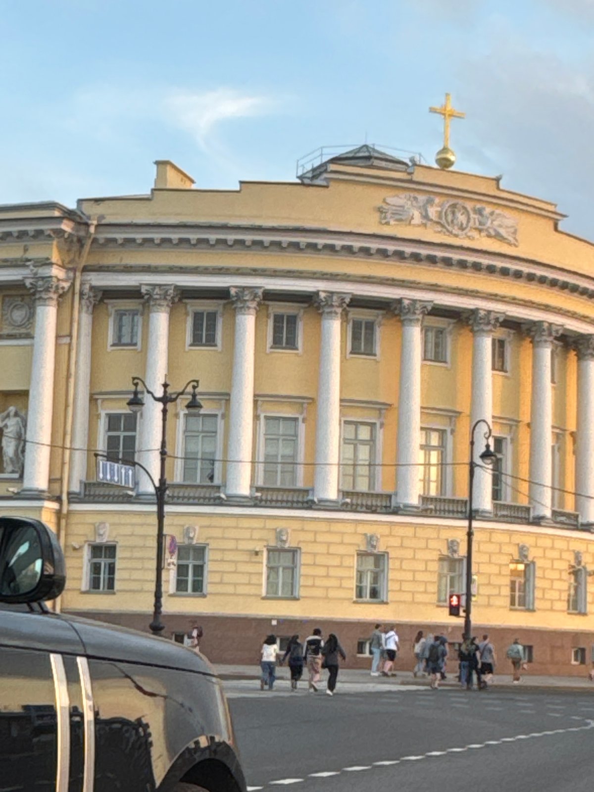 Evening golden hour illuminates Saint Petersburg's Palace Square monuments