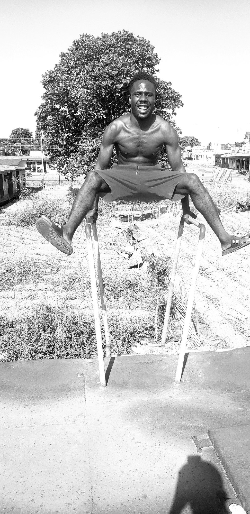 Man performs gymnastics on parallel bars in Narayi, Nigeria