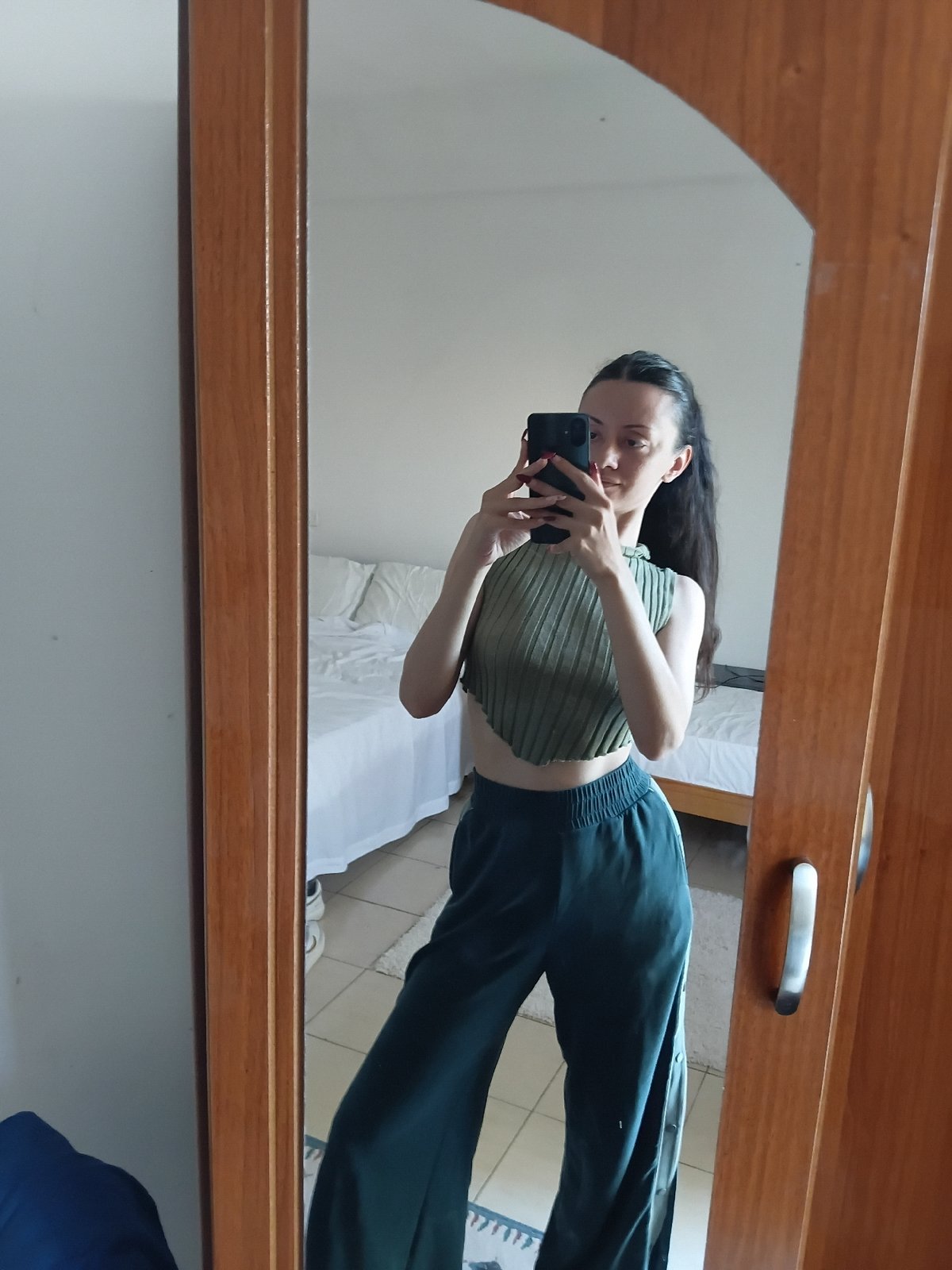 Woman takes mirror selfies in bedroom, Vlora Albania