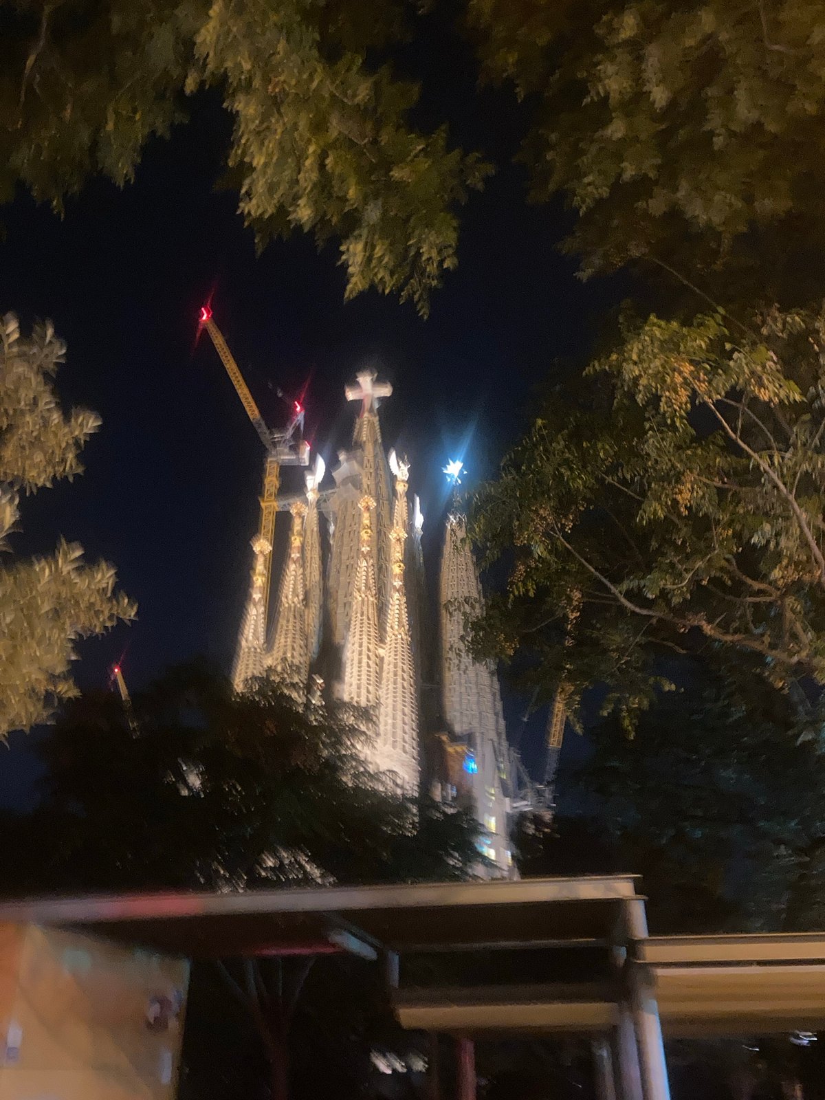 Sagrada Familia illuminated at night with construction ongoing