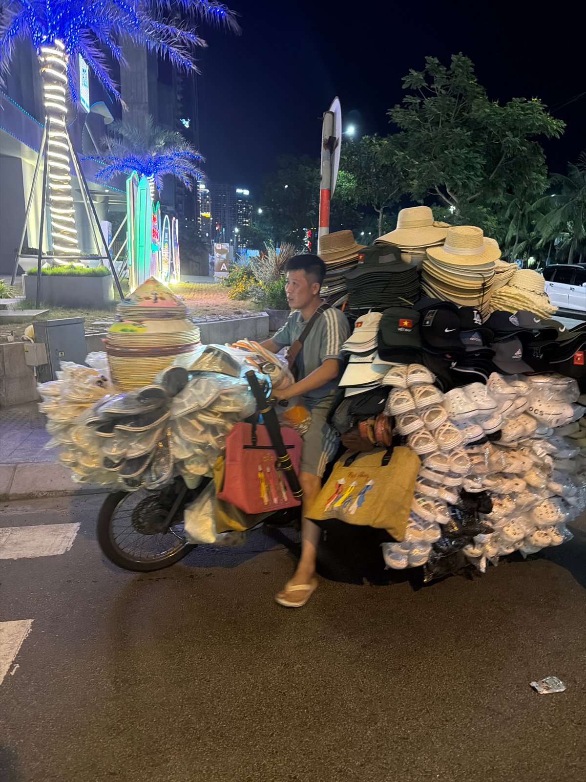 Merchandise-laden motorcycle on a Da Nang street at night