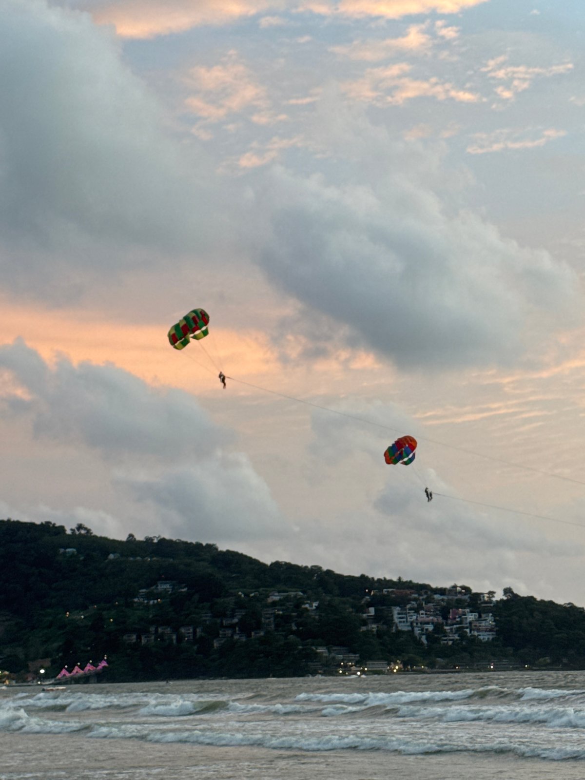 Patong Beach sunset: parasails, waves, and a stormy sky